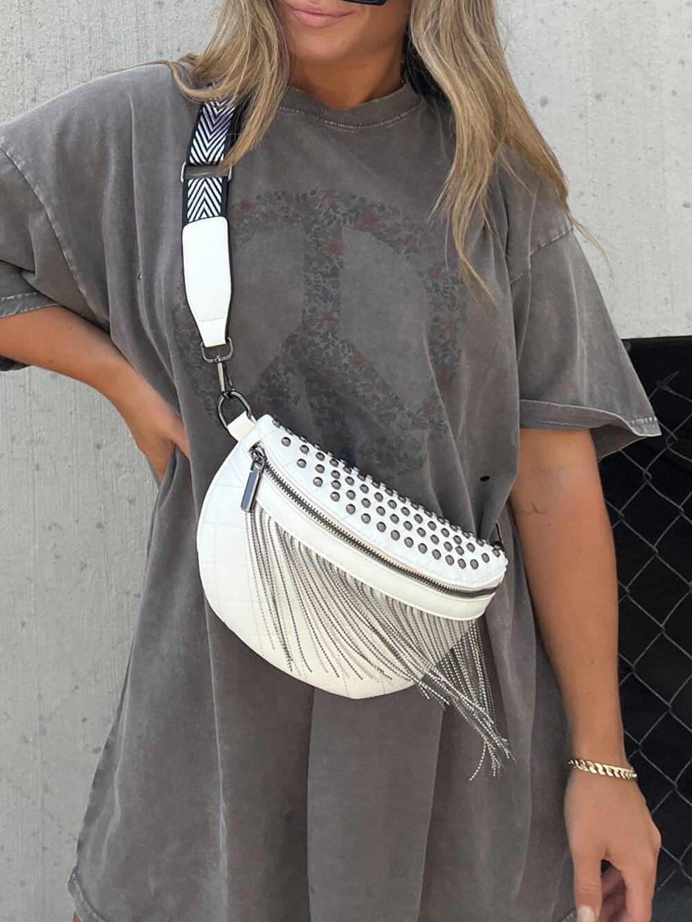 Studded Tassel Crossbody Belt Bag" can be rewritten as "Embellished Tassel Crossbody Belt Bag.