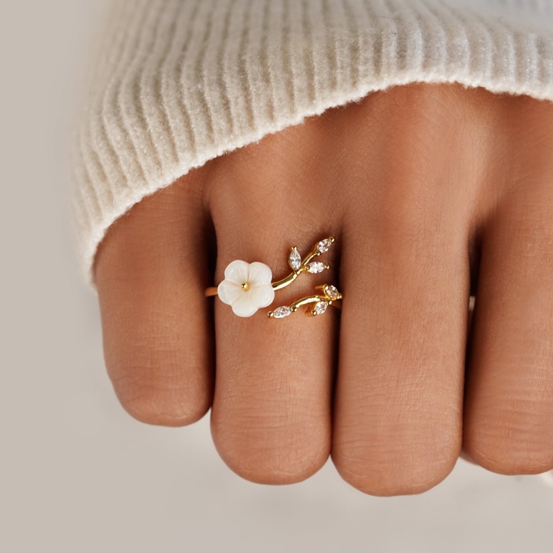 Miriam – Gold Ring Adorned with White Floral Design