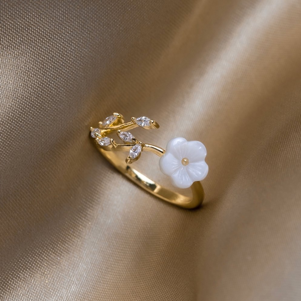Miriam – Gold Ring Adorned with White Floral Design